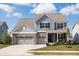 Charming two-story home with blue siding, brick accents, and a spacious two-car garage at 5770 Flagler Ln, Brownsburg, IN 46112