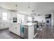 Spacious kitchen with an island, stainless steel appliances, and a view of the dining and living areas at 5770 Flagler Ln, Brownsburg, IN 46112