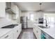 Well-lit kitchen featuring white cabinets, stainless steel appliances, and a spacious island with sink at 5770 Flagler Ln, Brownsburg, IN 46112