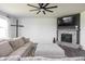 Comfortable living room featuring a cozy fireplace and a modern ceiling fan at 5770 Flagler Ln, Brownsburg, IN 46112