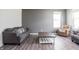 Comfortable living room with gray sofa, plush armchair, and rustic coffee table at 5770 Flagler Ln, Brownsburg, IN 46112