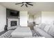 Cozy living room with a stone fireplace, mounted TV, and plush furniture at 5770 Flagler Ln, Brownsburg, IN 46112