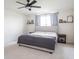 Cozy bedroom with a ceiling fan, a comfortable bed, and natural light from the window at 5770 Flagler Ln, Brownsburg, IN 46112