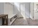 Mudroom featuring a built-in bench with storage, a white door, and a rug at 5770 Flagler Ln, Brownsburg, IN 46112