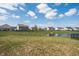 Beautiful view of a neighborhood pond surrounded by green space and homes on a sunny day at 5770 Flagler Ln, Brownsburg, IN 46112