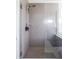 Modern shower featuring gray tiled walls, glass enclosure, and sleek fixtures at 5770 Flagler Ln, Brownsburg, IN 46112