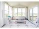 Bright sunroom featuring large windows, a vaulted ceiling, and play equipment at 5770 Flagler Ln, Brownsburg, IN 46112