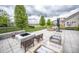 Spacious backyard patio with a stone firepit, comfortable seating, and a view of the pond at 6064 Bartley Dr, Noblesville, IN 46062