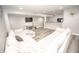 Open concept basement living area with L-shaped couch, recessed lighting, and modern flooring at 6064 Bartley Dr, Noblesville, IN 46062