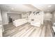 Open concept finished basement with L-shaped couch and walkout stairwell at 6064 Bartley Dr, Noblesville, IN 46062