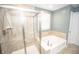 Bathroom featuring a glass-enclosed shower and a soaking tub at 6064 Bartley Dr, Noblesville, IN 46062