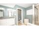 Bathroom featuring a double vanity, granite countertops, and a tiled shower at 6064 Bartley Dr, Noblesville, IN 46062