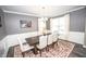 Well-lit dining room with a large window, a chandelier, and a stylish rug at 6064 Bartley Dr, Noblesville, IN 46062