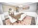 Inviting dining room with a large wood table, modern chandelier, and stylish decor at 6064 Bartley Dr, Noblesville, IN 46062