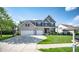 Beautiful two-story home featuring a manicured lawn, brick accents, and a three-car garage at 6064 Bartley Dr, Noblesville, IN 46062