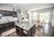 Modern kitchen with dark cabinets, light countertops, stainless steel appliances and island with breakfast bar at 6064 Bartley Dr, Noblesville, IN 46062