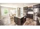 Modern kitchen with granite island, stainless steel appliances, and stylish pendant lighting above the island at 6064 Bartley Dr, Noblesville, IN 46062