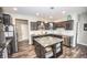 Bright kitchen featuring dark cabinets, stainless steel appliances, granite countertops, island and breakfast bar at 6064 Bartley Dr, Noblesville, IN 46062