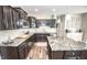 Contemporary kitchen featuring dark cabinets, granite countertops, stainless steel appliances, and a large island at 6064 Bartley Dr, Noblesville, IN 46062
