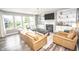 Bright living room with fireplace, built-in shelves, tv, leather furniture, and large windows at 6064 Bartley Dr, Noblesville, IN 46062