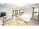 Bright main bedroom with sitting area, luxury vinyl plank flooring and stylish decor at 6064 Bartley Dr, Noblesville, IN 46062