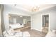 Spacious main bedroom featuring a sitting area and luxury vinyl plank flooring at 6064 Bartley Dr, Noblesville, IN 46062
