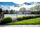 Community pool with green landscaping behind a black fence, perfect for enjoying a sunny day at 6064 Bartley Dr, Noblesville, IN 46062