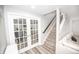 Staircase with access to the exercise area with double glass doors at 6064 Bartley Dr, Noblesville, IN 46062