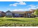 Backyard showing a covered patio area with well maintained lawn, ideal for outdoor living and relaxation at 6153 Dugan Dr, Whitestown, IN 46075