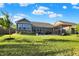 Manicured backyard with a covered patio, providing a serene space for relaxation and enjoying the outdoor scenery at 6153 Dugan Dr, Whitestown, IN 46075