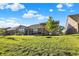 Spacious backyard with a covered patio and well-manicured lawn, offering plenty of room for outdoor activities at 6153 Dugan Dr, Whitestown, IN 46075