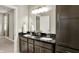 This bathroom features double sinks set in a granite countertop with ample storage, blending elegance with functionality at 6153 Dugan Dr, Whitestown, IN 46075