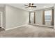 Large bedroom featuring neutral carpet, a ceiling fan, and ample natural light from the two windows at 6153 Dugan Dr, Whitestown, IN 46075