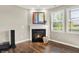 Cozy fireplace with decorative mantle, hardwood floors, and large windows for natural light at 6153 Dugan Dr, Whitestown, IN 46075