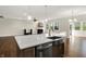 Modern kitchen island features a stainless steel farmhouse sink, beautiful countertops and wood-look floors at 6153 Dugan Dr, Whitestown, IN 46075