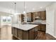Well-equipped kitchen with island, stainless steel appliances and dark brown cabinetry at 6153 Dugan Dr, Whitestown, IN 46075