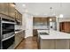 Beautiful kitchen features stainless appliances, gas range, and a large island with a farmhouse sink at 6153 Dugan Dr, Whitestown, IN 46075
