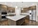 Spacious kitchen boasts a large island, stainless appliances, and a stylish backsplash at 6153 Dugan Dr, Whitestown, IN 46075