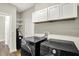 Well-equipped laundry room with modern washer and dryer and plenty of cabinet space for storage at 6153 Dugan Dr, Whitestown, IN 46075