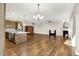 Open concept kitchen and living room features a fireplace, wood-look floors, and lots of light at 6153 Dugan Dr, Whitestown, IN 46075