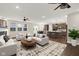 Open-concept living room showcasing modern decor and seamless flow into the kitchen and dining areas at 6153 Dugan Dr, Whitestown, IN 46075