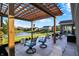 This covered patio overlooks a pond, offering a serene retreat with comfortable seating and scenic views at 6153 Dugan Dr, Whitestown, IN 46075