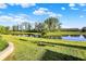Scenic pond view showcasing a well-maintained lawn and tree, creating a peaceful natural setting at 6153 Dugan Dr, Whitestown, IN 46075