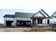 New construction home with a garage and covered porch awaiting finishing touches at 6203 Hampton Walk Blvd, McCordsville, IN 46055