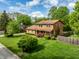 Aerial view showcasing the home's expansive yard, mature trees and well-manicured landscaping at 6938 Rio Grande Dr, Indianapolis, IN 46217