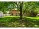 Beautiful backyard with a stone facade and back patio view of the home at 6938 Rio Grande Dr, Indianapolis, IN 46217