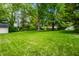 Expansive backyard featuring a lush lawn and mature trees, perfect for outdoor activities and relaxation at 6938 Rio Grande Dr, Indianapolis, IN 46217