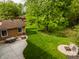 Aerial view of backyard with patio area, dining set, fire pit, and lush lawn at 6938 Rio Grande Dr, Indianapolis, IN 46217