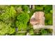 Overhead view of backyard with patio and firepit, surrounded by mature trees and lawn at 6938 Rio Grande Dr, Indianapolis, IN 46217