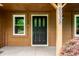 Close-up of the front door and covered porch, with house number displayed at 6938 Rio Grande Dr, Indianapolis, IN 46217